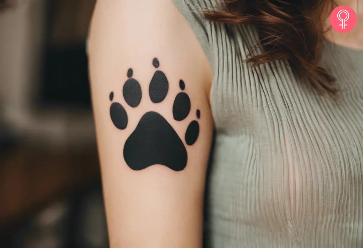 Ferret paw print tattoo on the upper arm