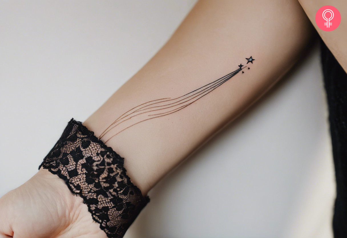 Woman with a fine line shooting star tattoo on her hand