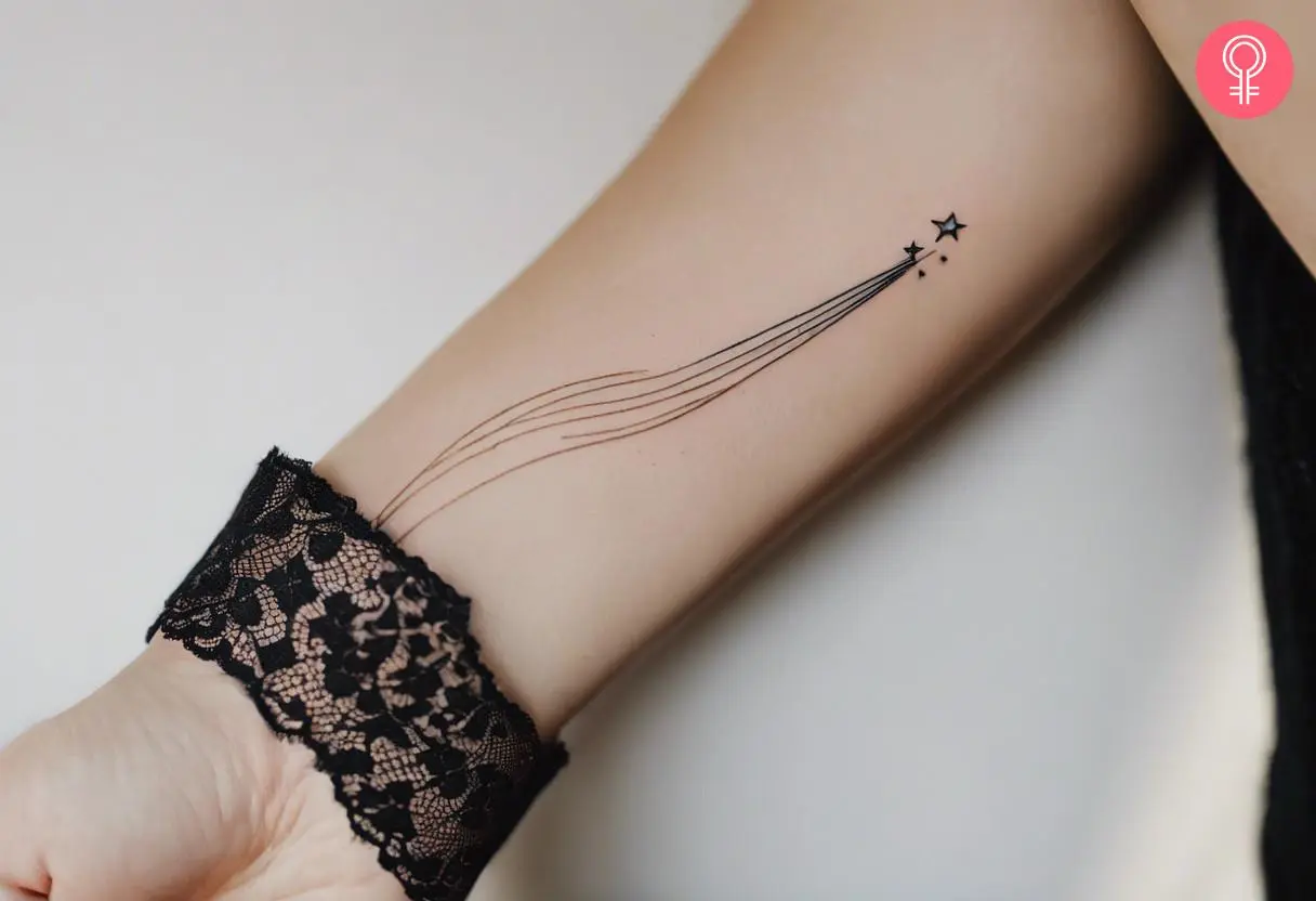 Woman with a fine line shooting star tattoo on her hand