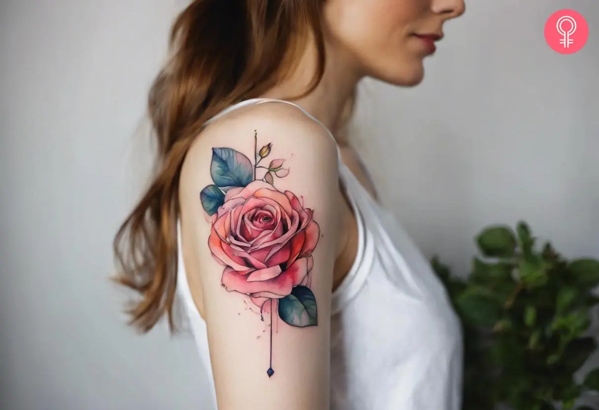 An art nouveau style rose tattoo on the upper arm of a woman