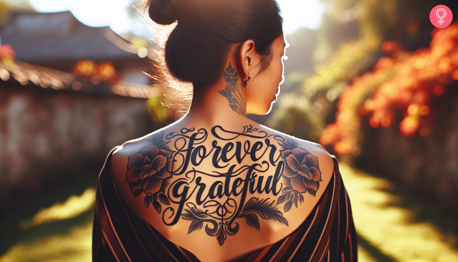 Forever grateful gratitude tattoo on the upper back of a woman