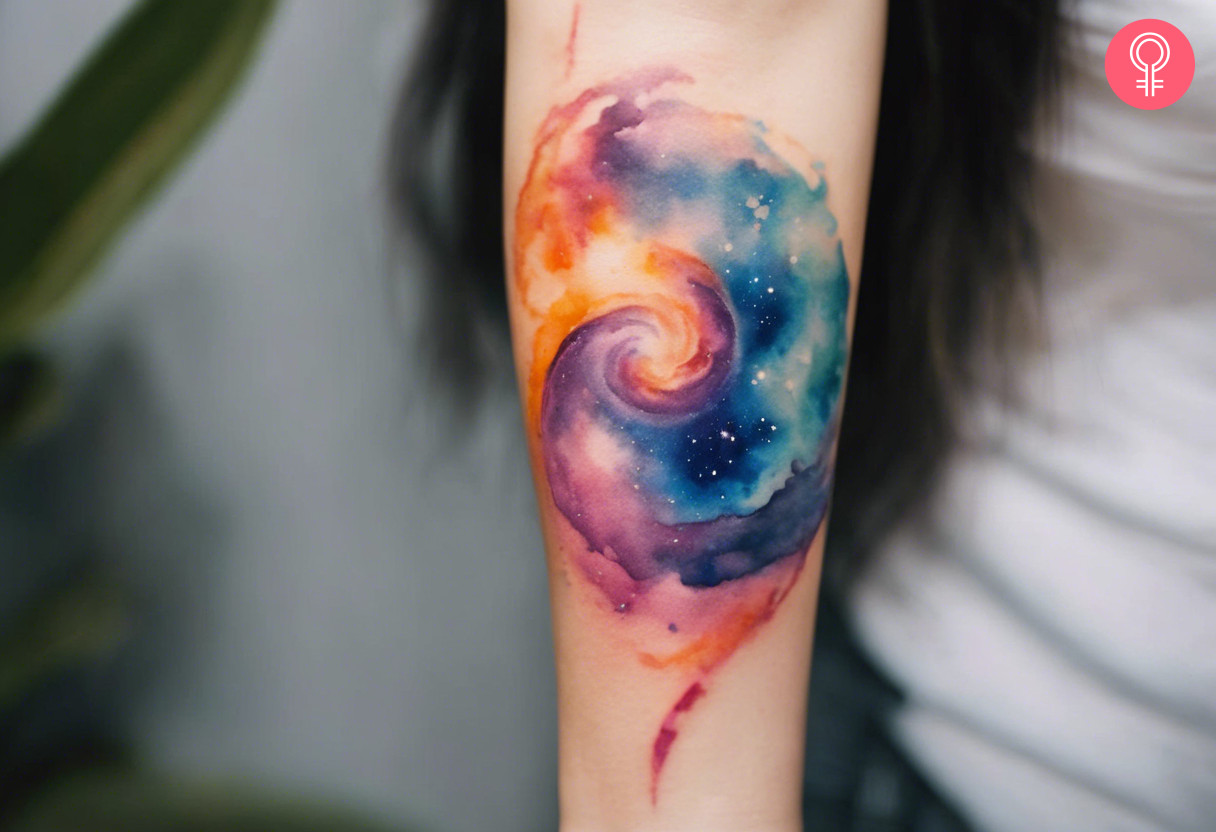 Galaxy swirl tattoo on the forearm of a woman