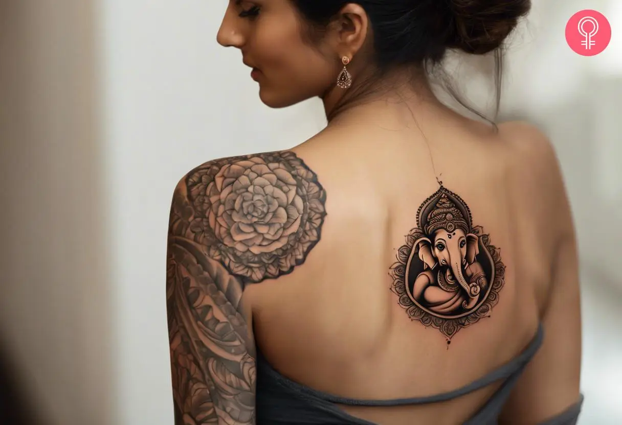 Ganesh tattoo on the back of a woman