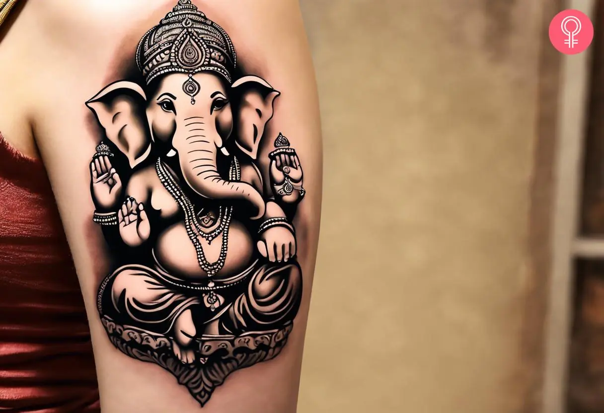 Ganesh tattoo on the upper arm of a woman