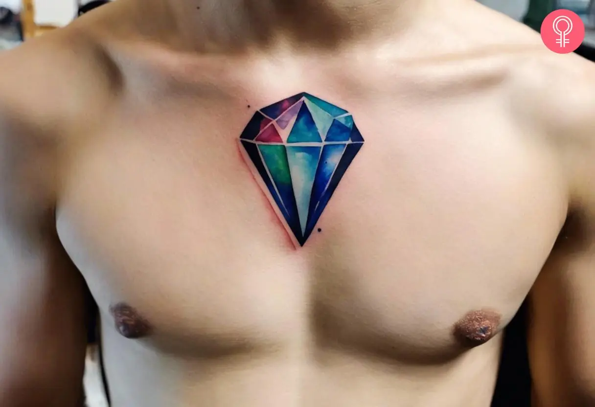 A watercolor style diamond gem tattoo on the chest of a man