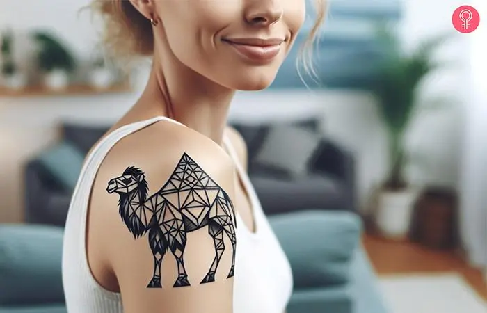 Woman with a geometric camel tattoo on the shoulder