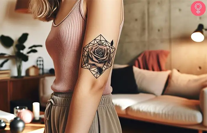 Geometric dead black rose tattoo on the upper arm of a woman