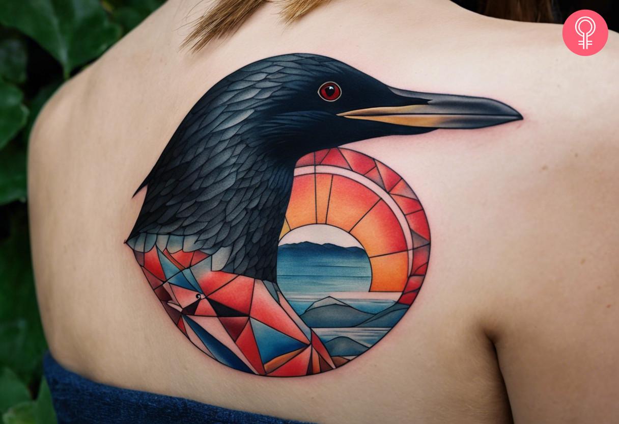 A geometric loon tattoo on the upper back