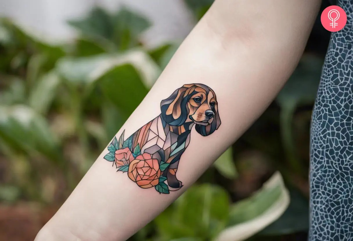 Geometric cocker spaniel tattoo on a woman’s forearm