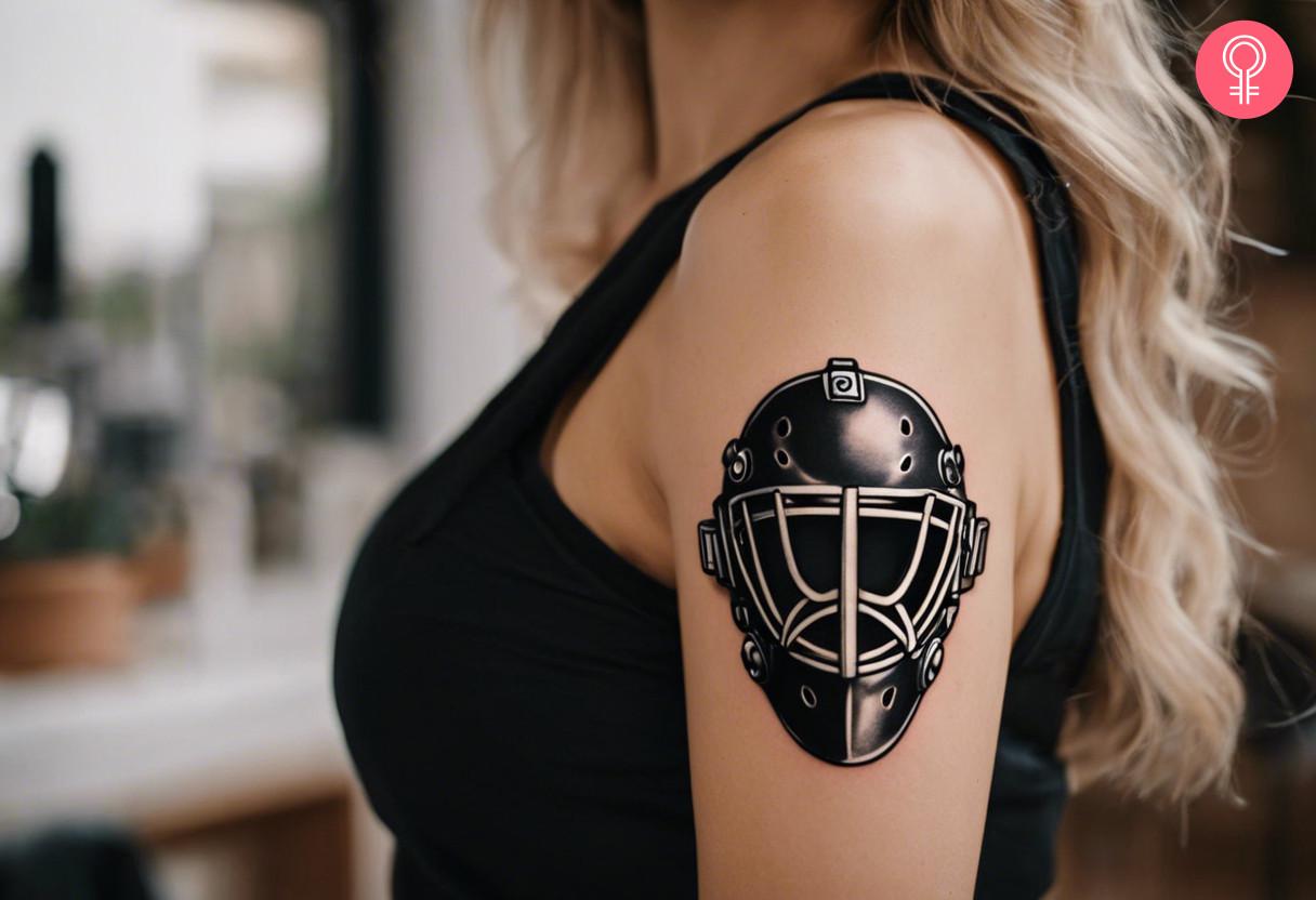 Goalie helmet tattoo on the upper arm