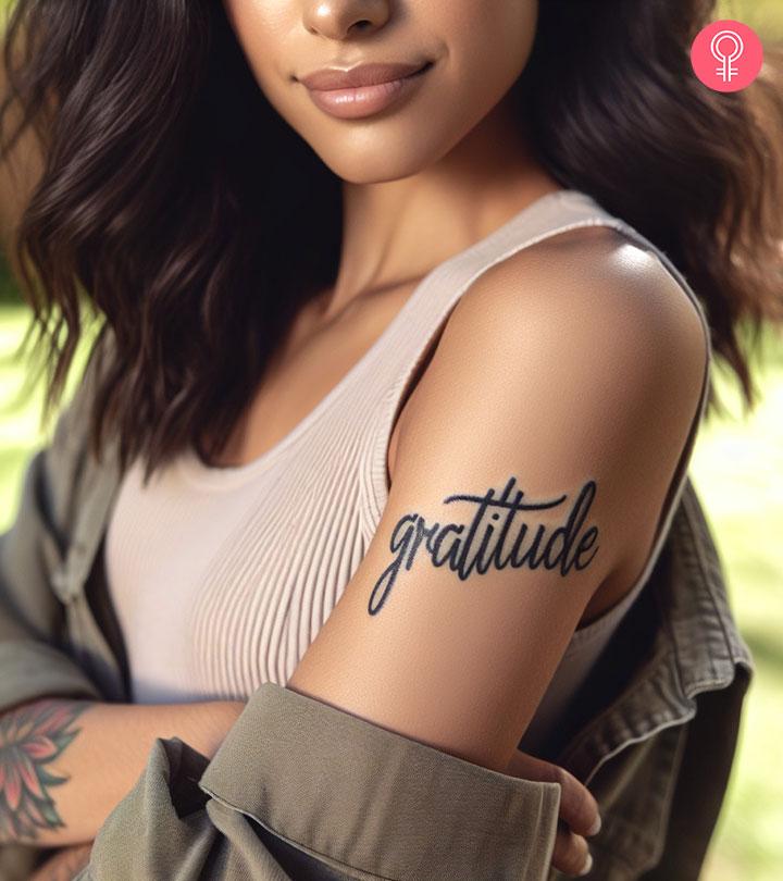 Gratitude tattoo on the upper arm of a woman