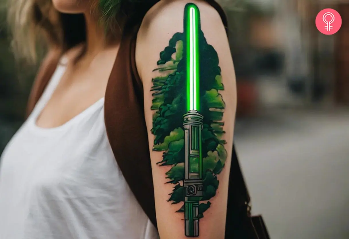 Green Lightsaber tattoo on a woman’s upper arm