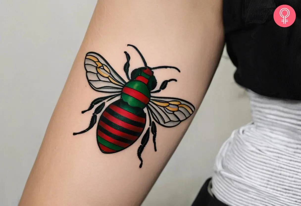 Woman with gucci bee tattoo on her arm