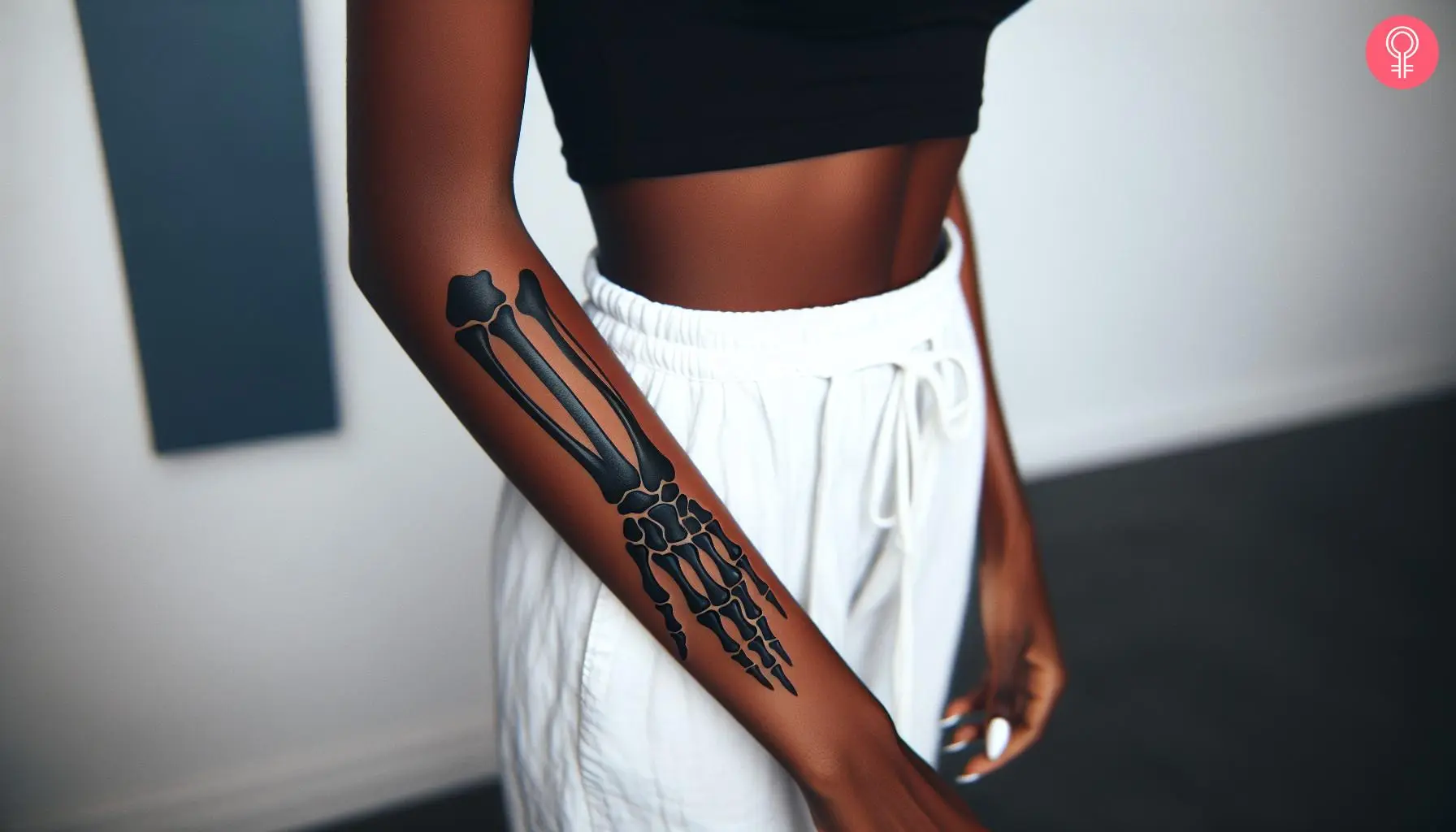 Woman with a hand bone tattoo on the forearm