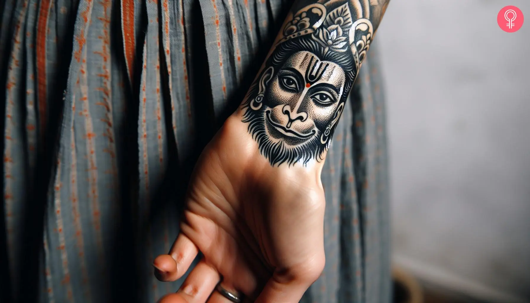 Woman with hanuman face tattoo on her wrist