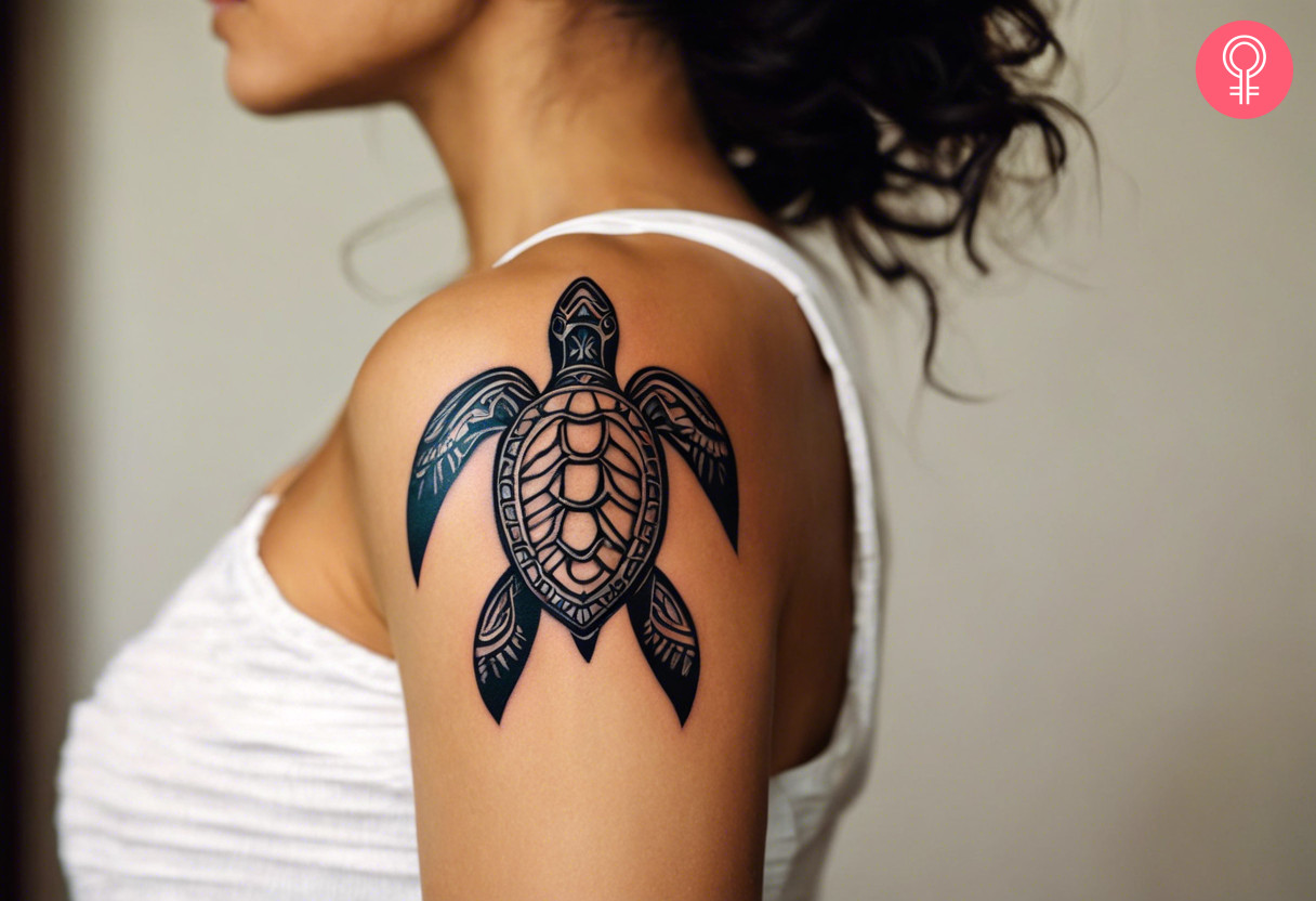 Hawaiian tribal turtle tattoo on a woman’s upper arm