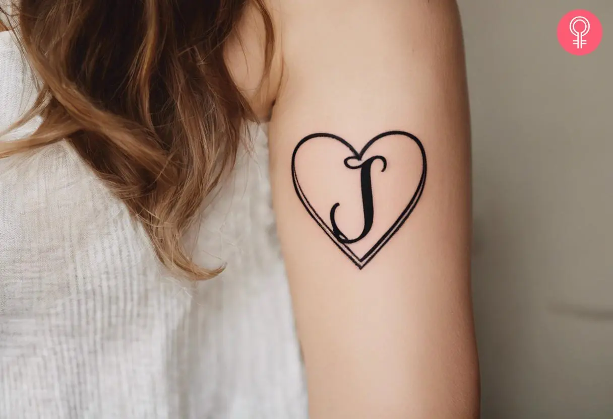 A woman with a heart and letter J tattoo on her arm