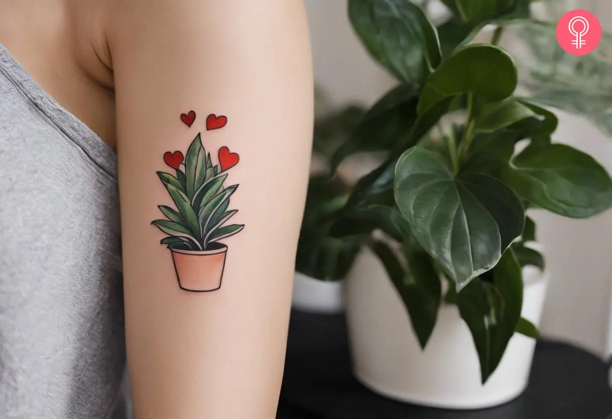 Houseplant with red hearts tattoo on the upper arm