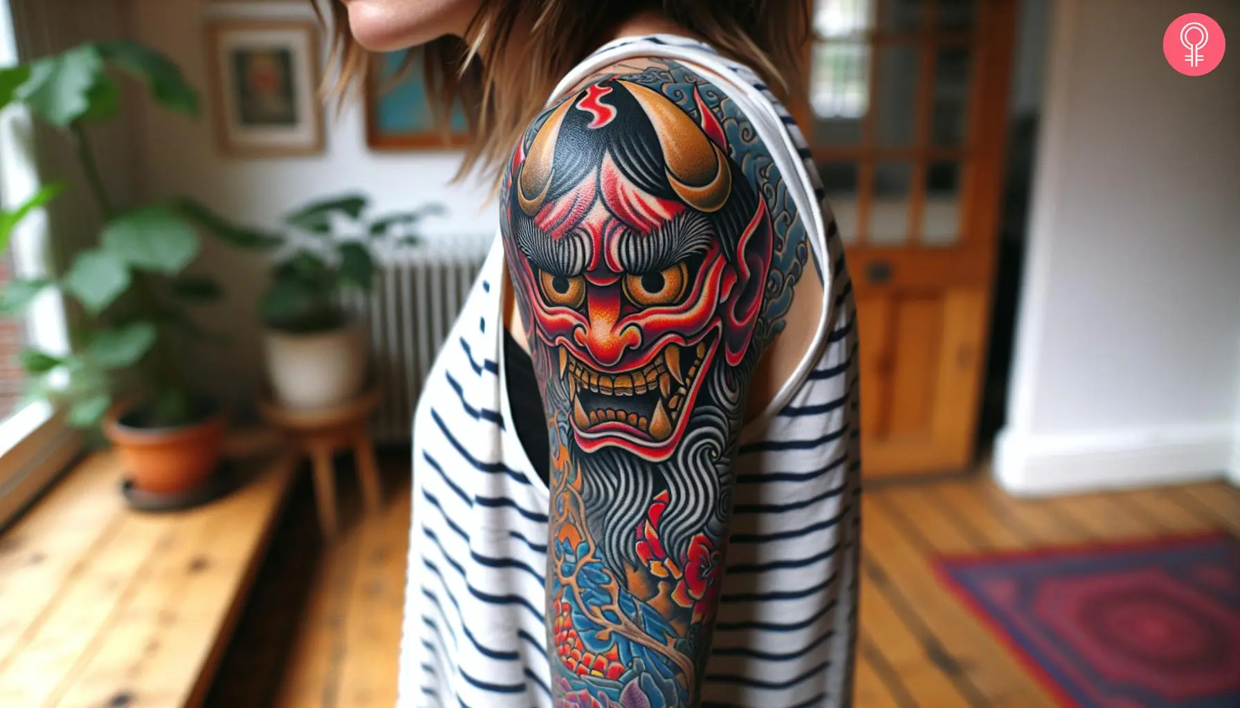 Japanese Oni Mask half-sleeve tattoo on the upper arm