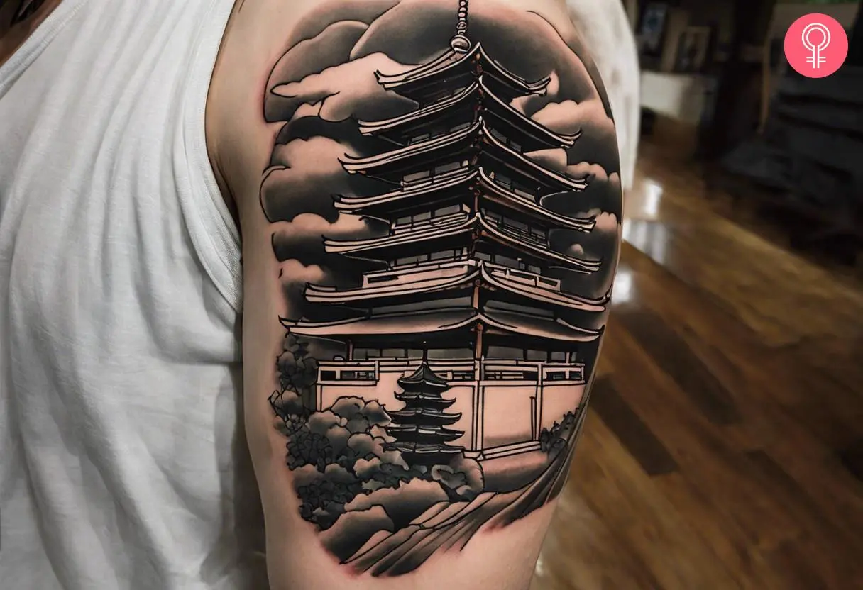 Japanese pagoda tattoo on the upper arm of a man