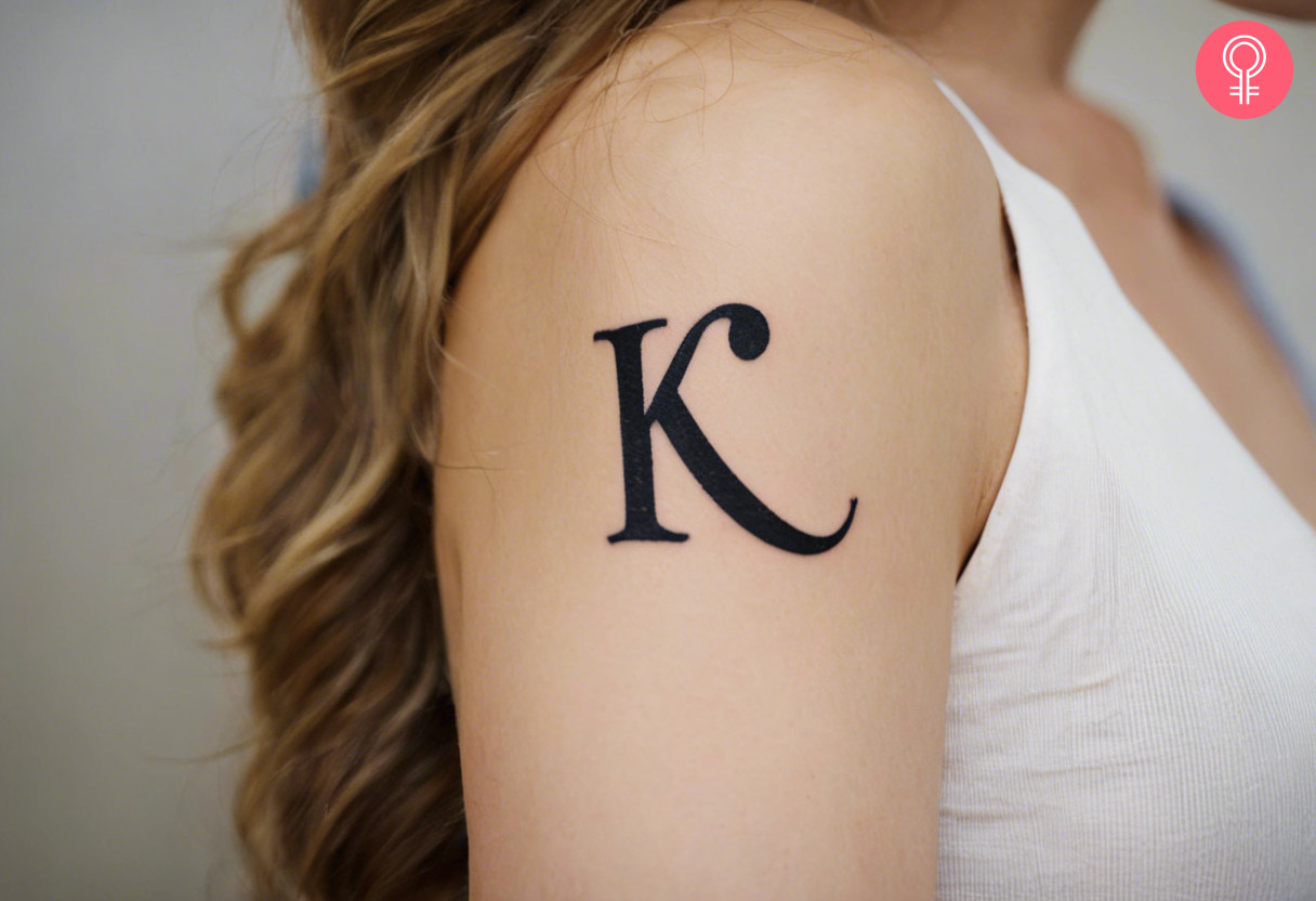 K-letter tattoo on a woman’s upper arm