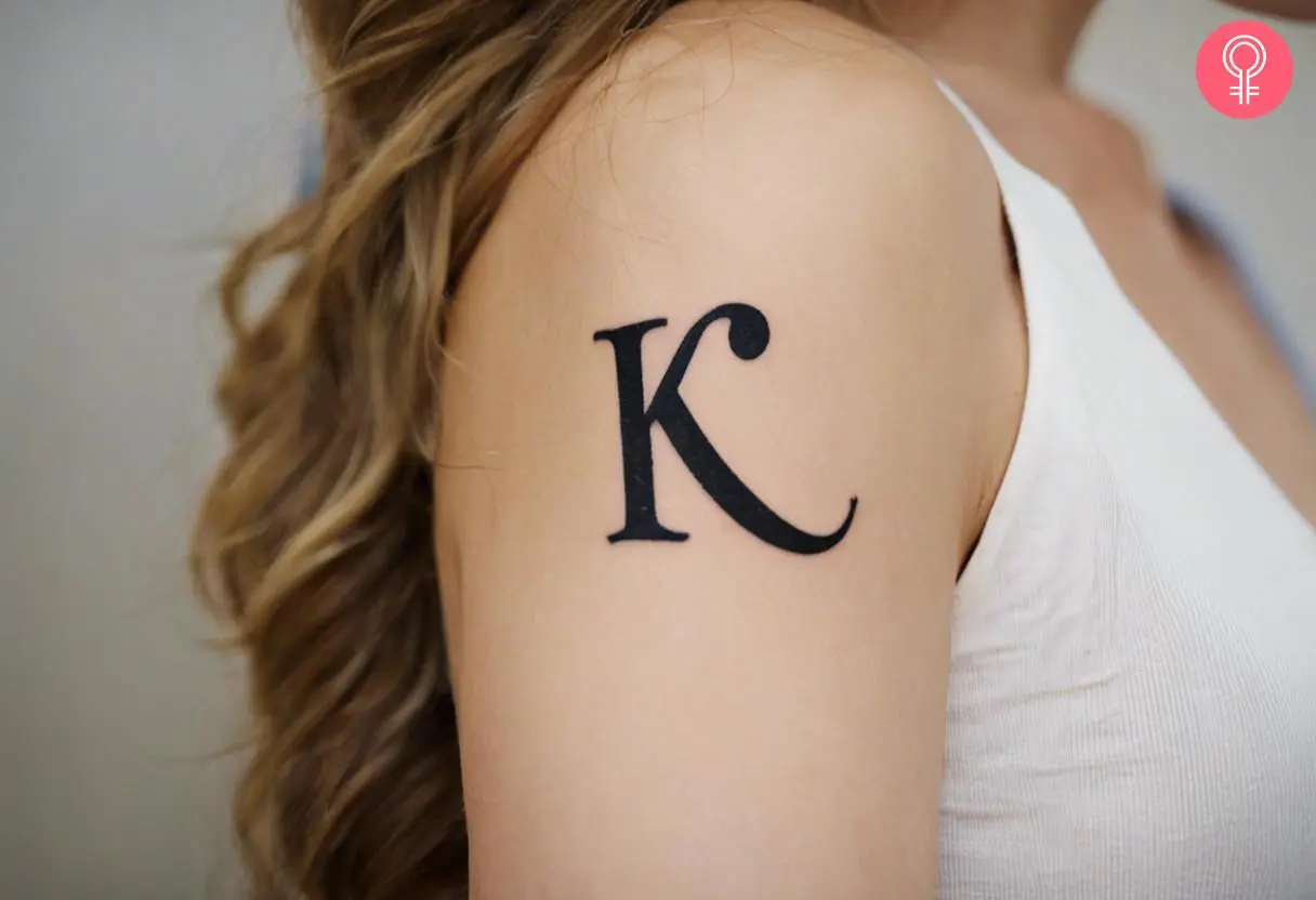 K-letter tattoo on a woman’s upper arm