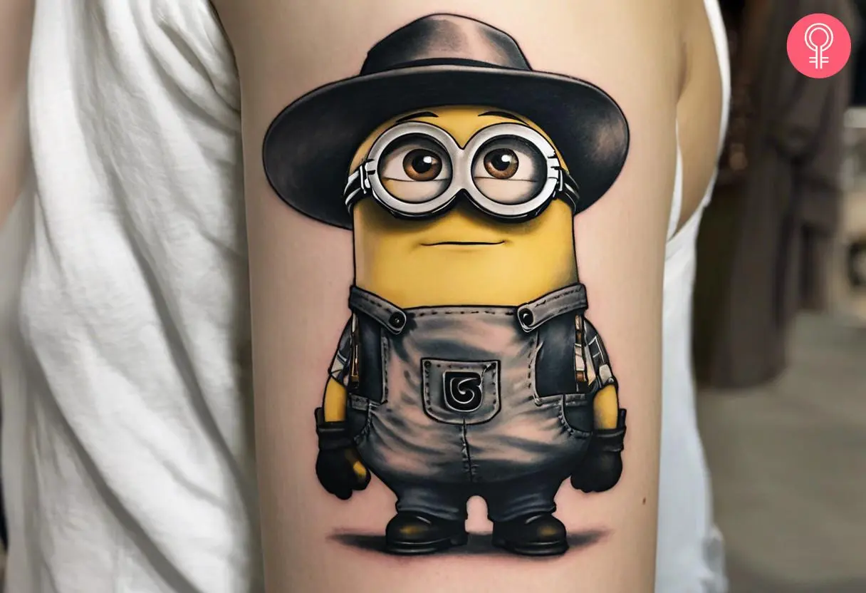 Kevin minion tattoo on the upper arm of a woman