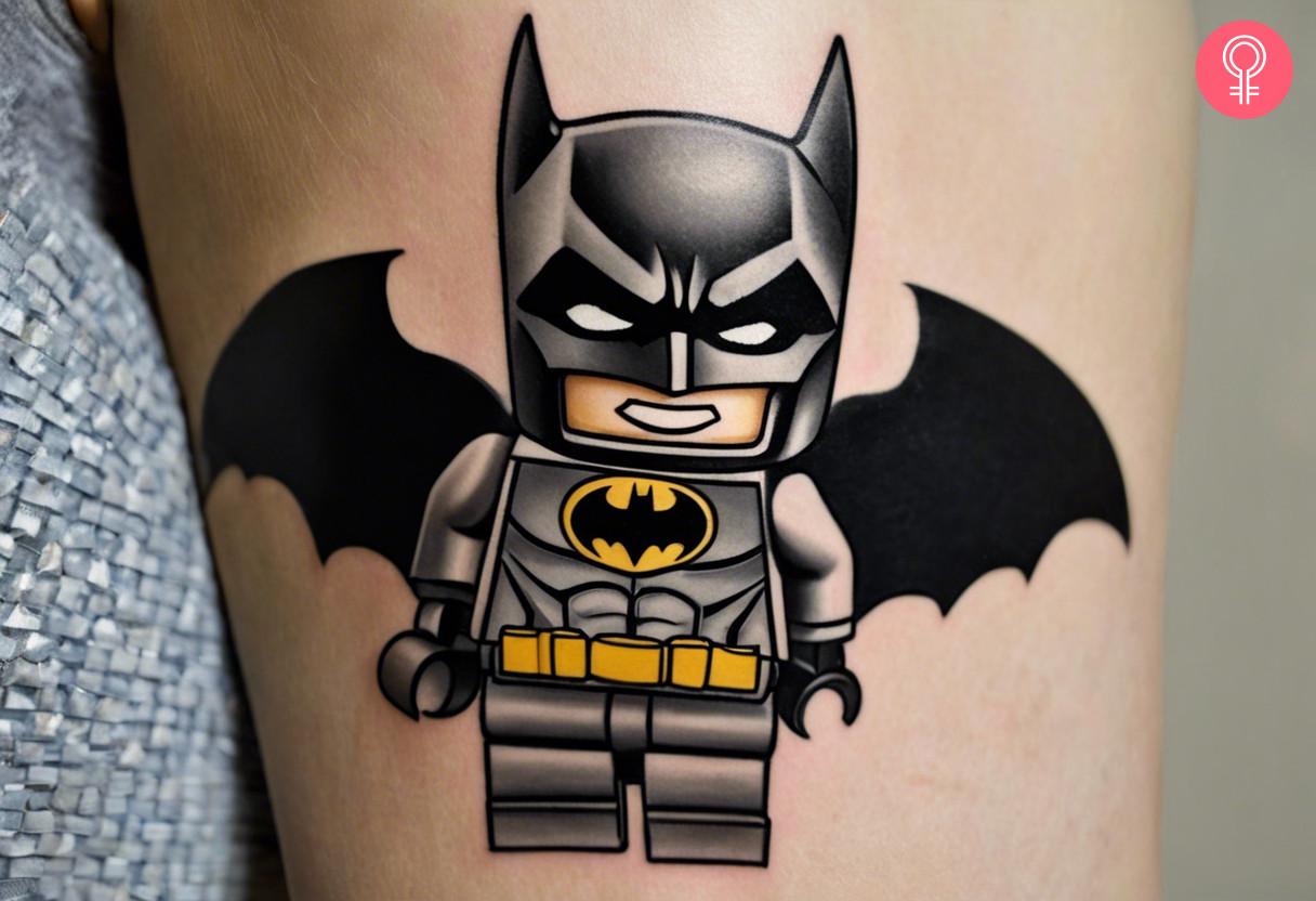 A woman with a colored LEGO Batman tattoo on her upper arm