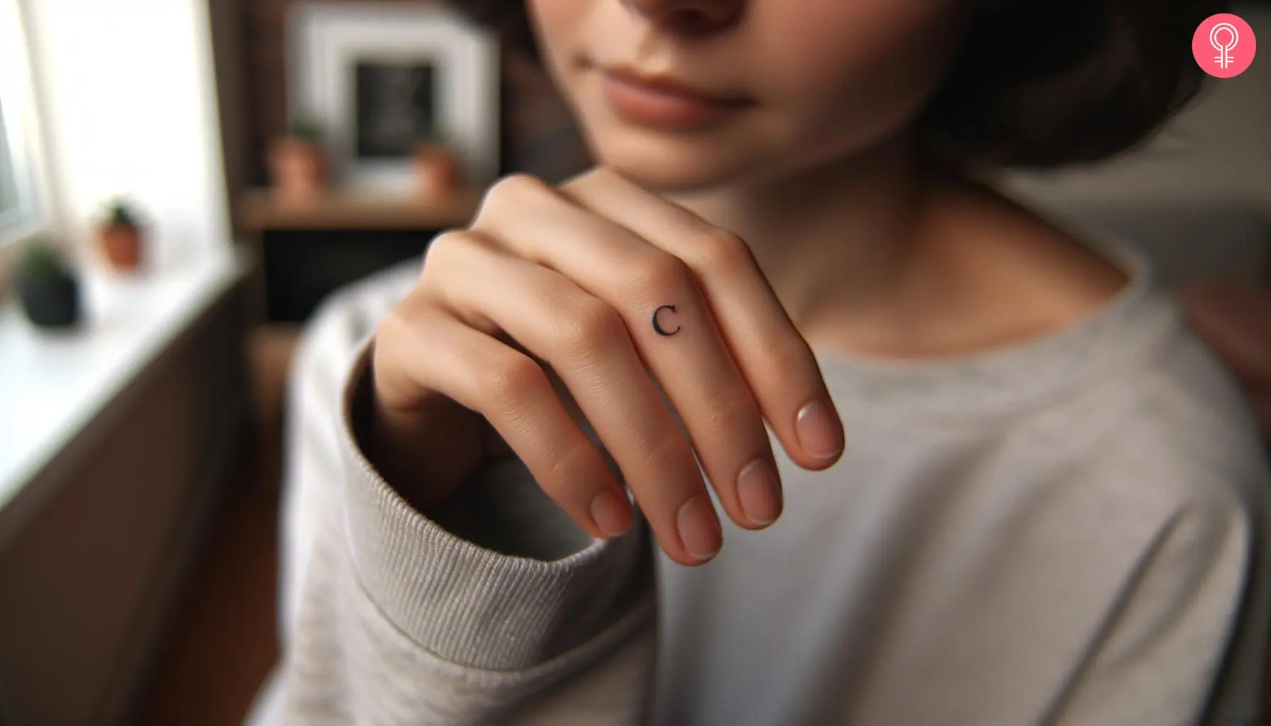 A woman with a simple letter c tattoo