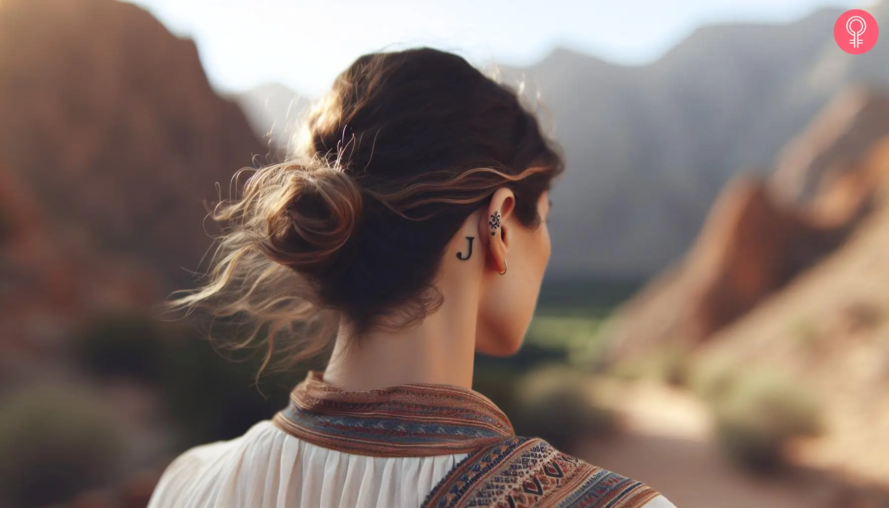 A woman with a letter J tattoo behind her ear