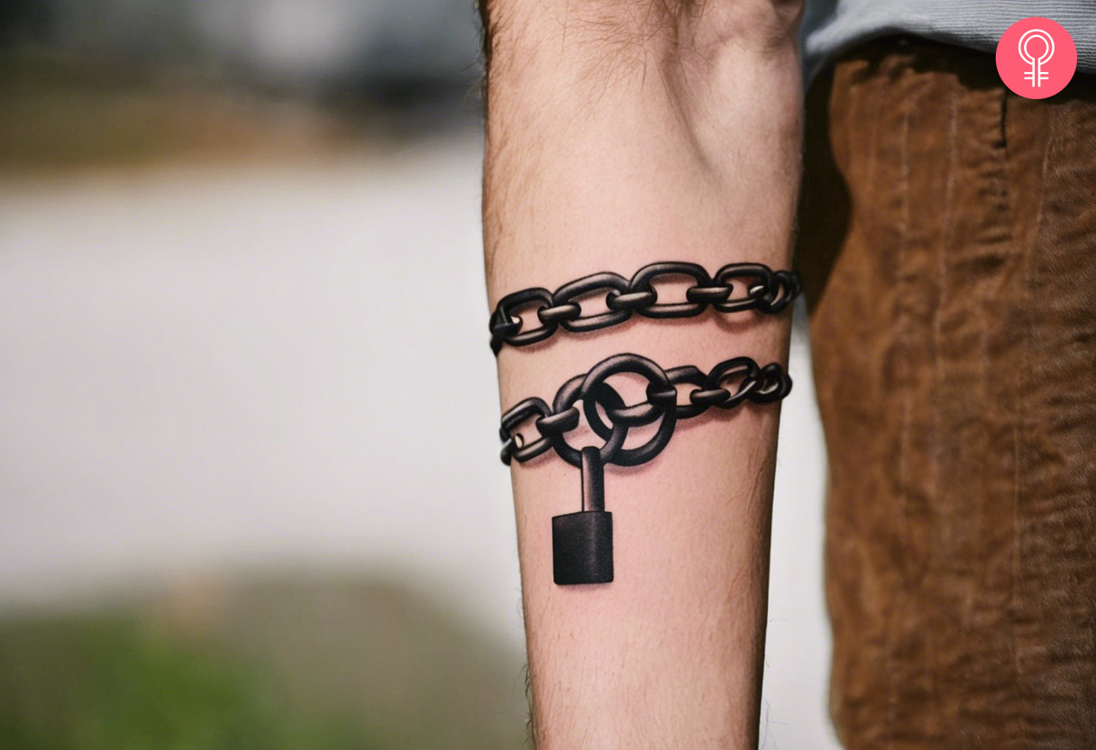 Man with lock and chain tattoo on his forearm