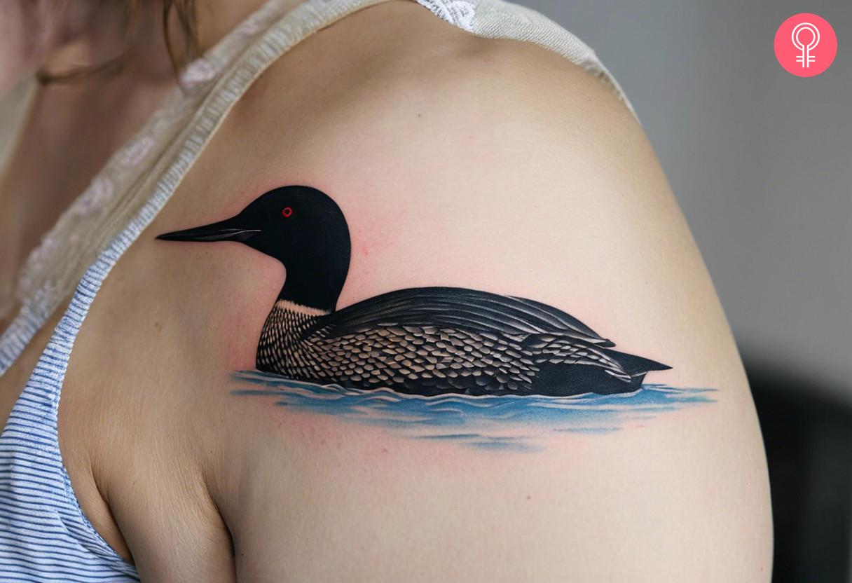 A loon bird tattoo on the upper arm