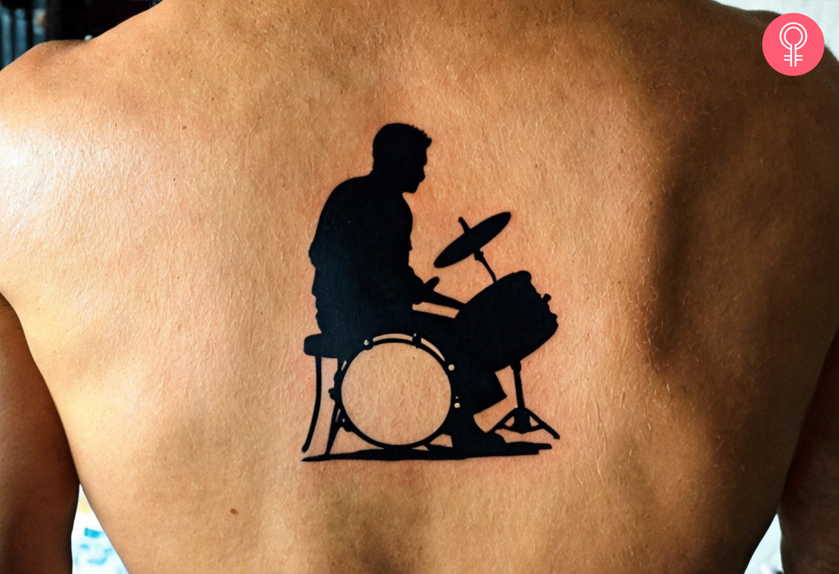 Man with a silhouette drum tattoo on the back