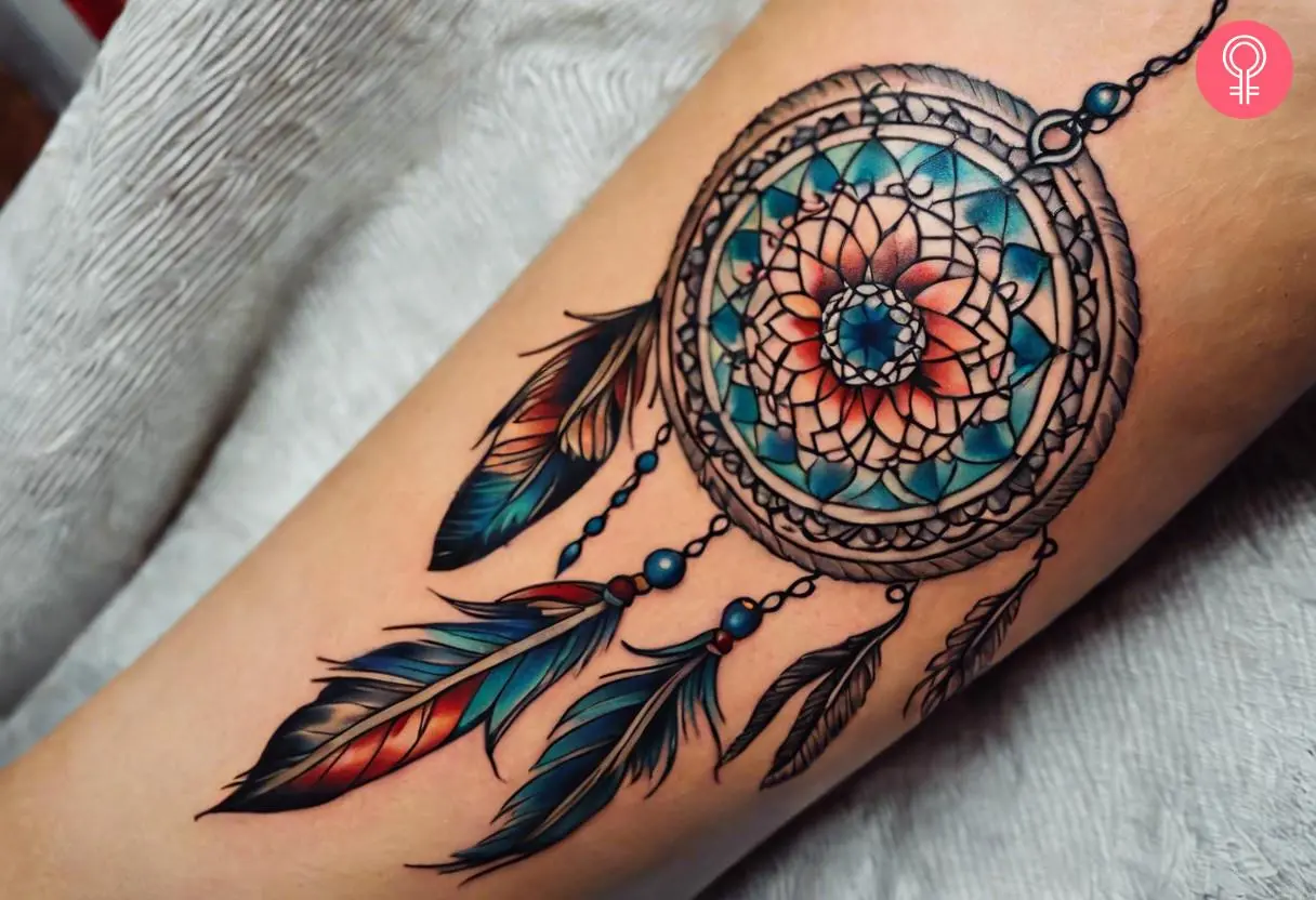 A mandala dreamcatcher tattoo on the forearm