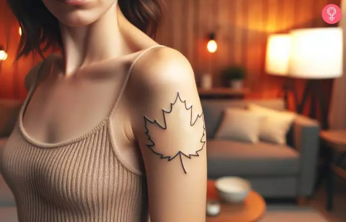 Outline Maple leaf tattoo on the upper arm