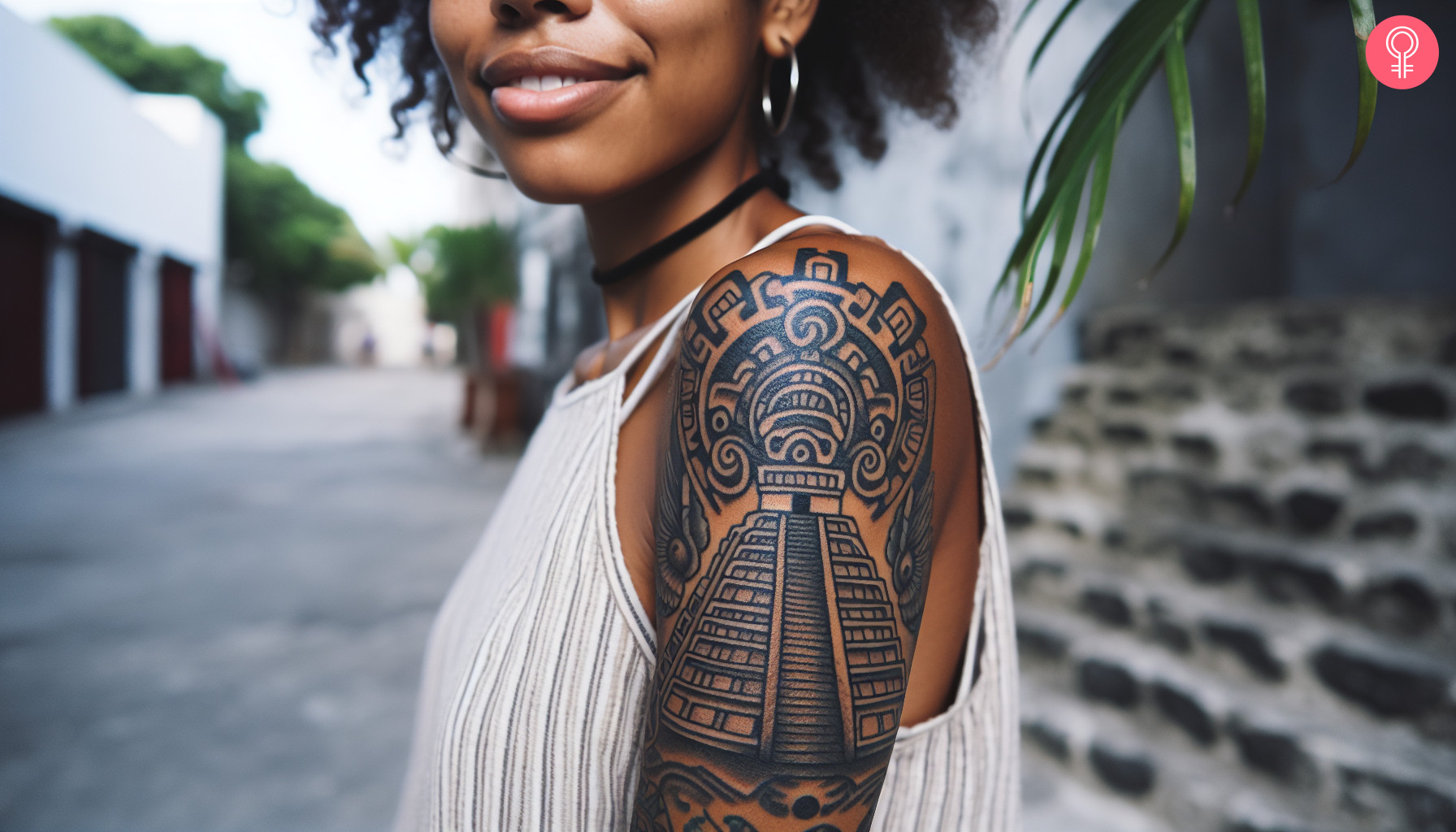 Mayan temple tattoo on a woman’s upper arm