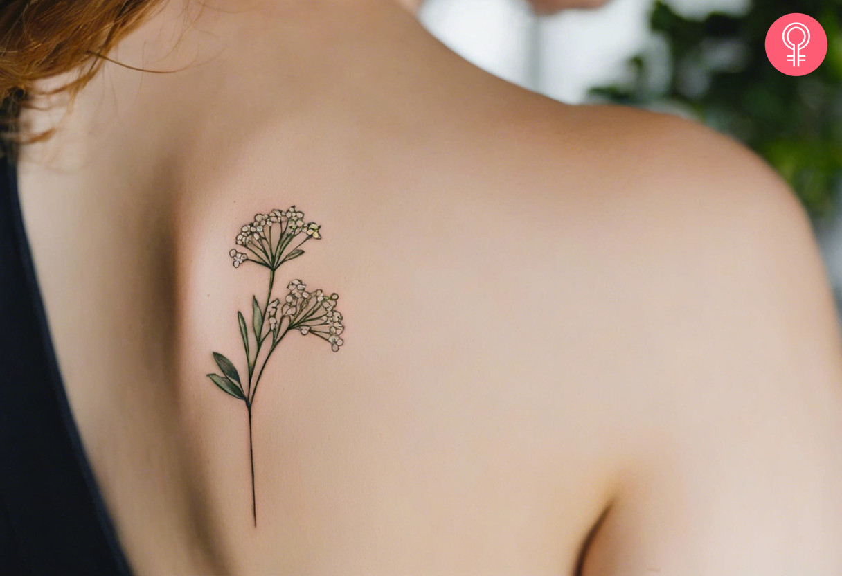 A simple and minimalistic baby’s breath tattoo on a woman’s shoulder