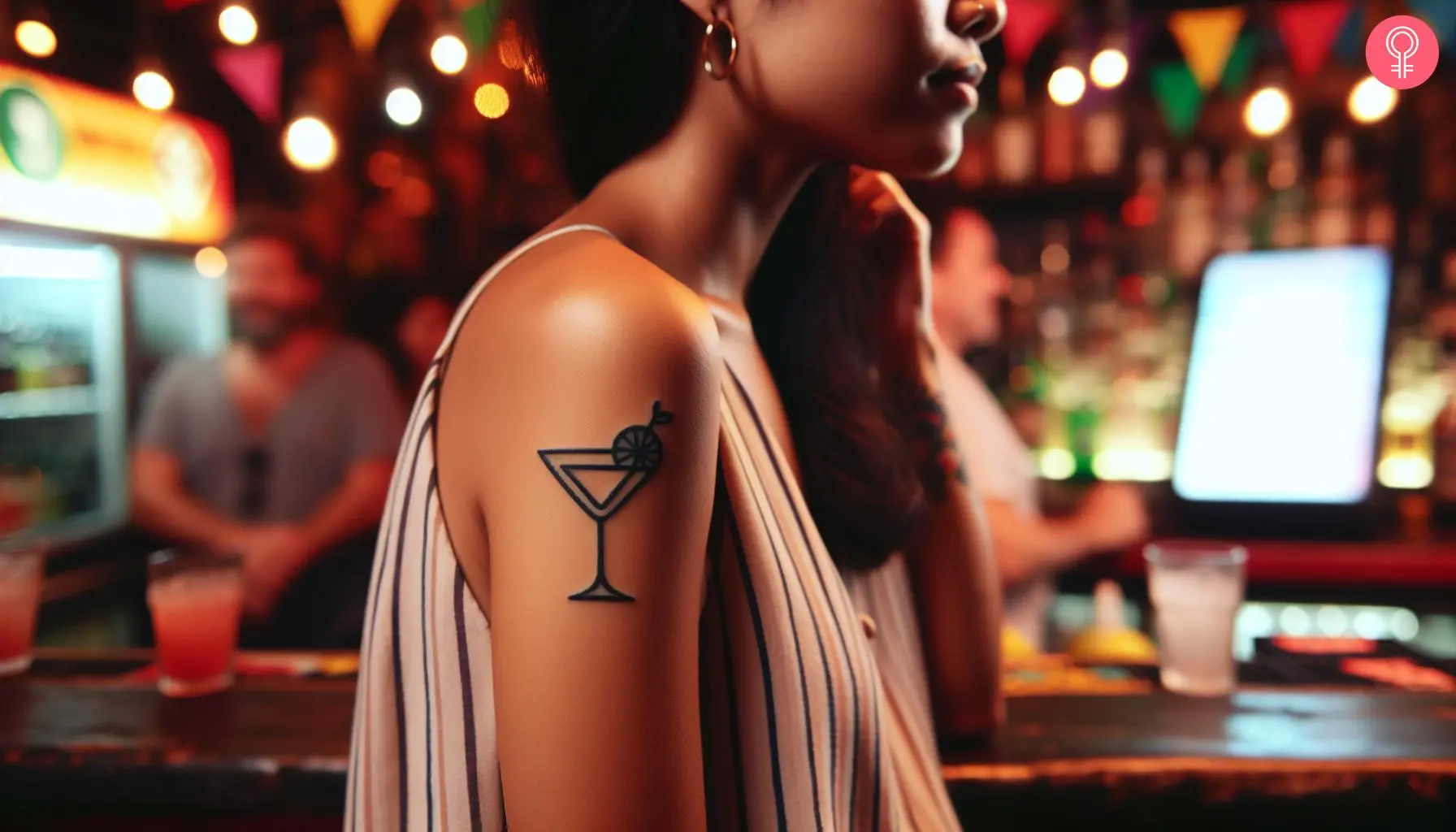 Woman with a minimalist bartender tattoo on the upper arm