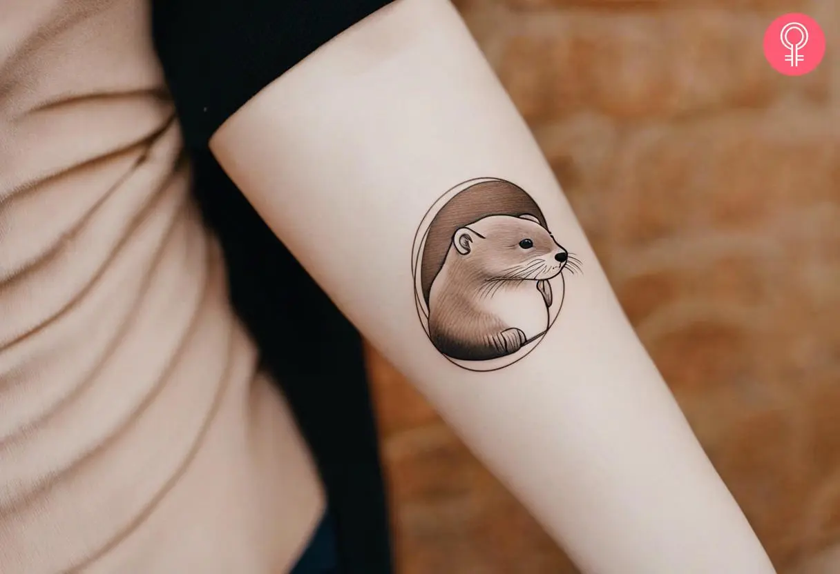 A minimalist otter tattoo on the forearm of a woman