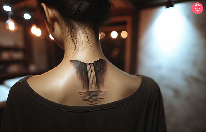 Minimalist outdoor tattoo on the back of a woman