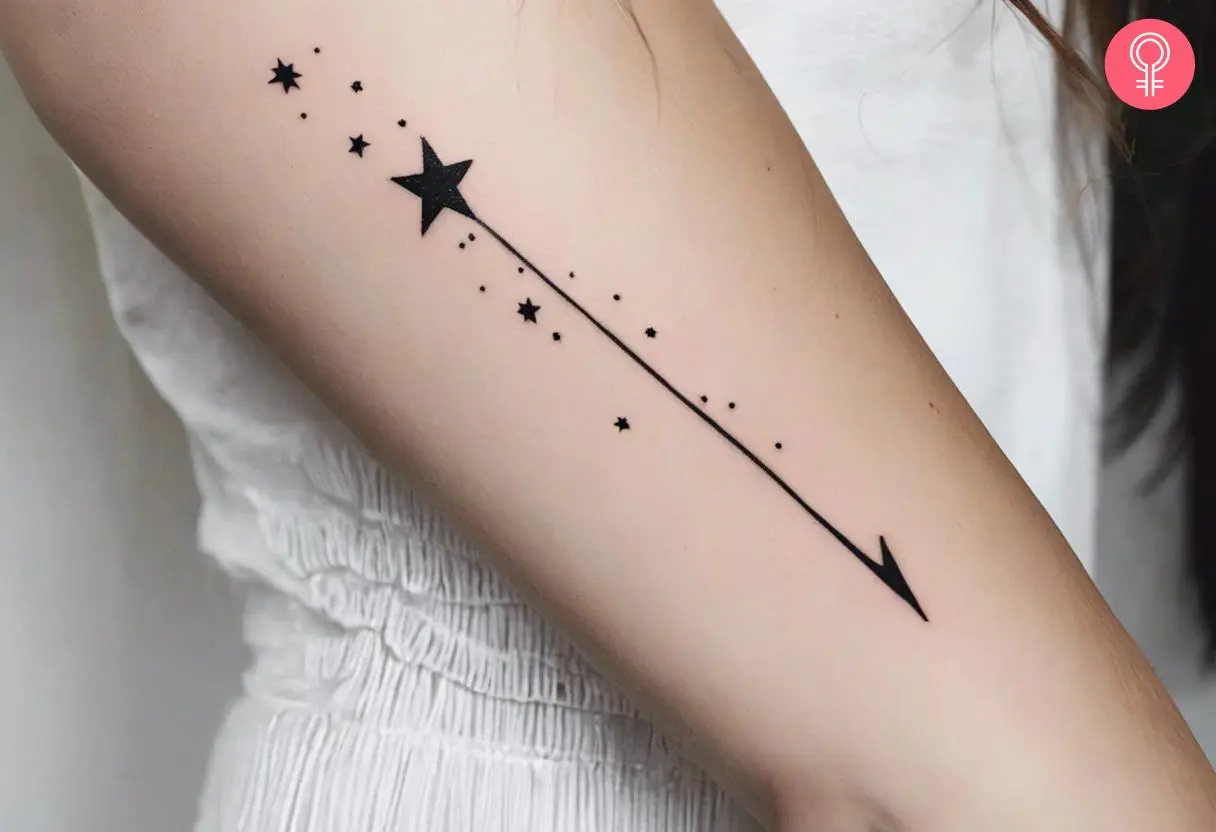 Woman with a minimalist shooting star tattoo on her arm