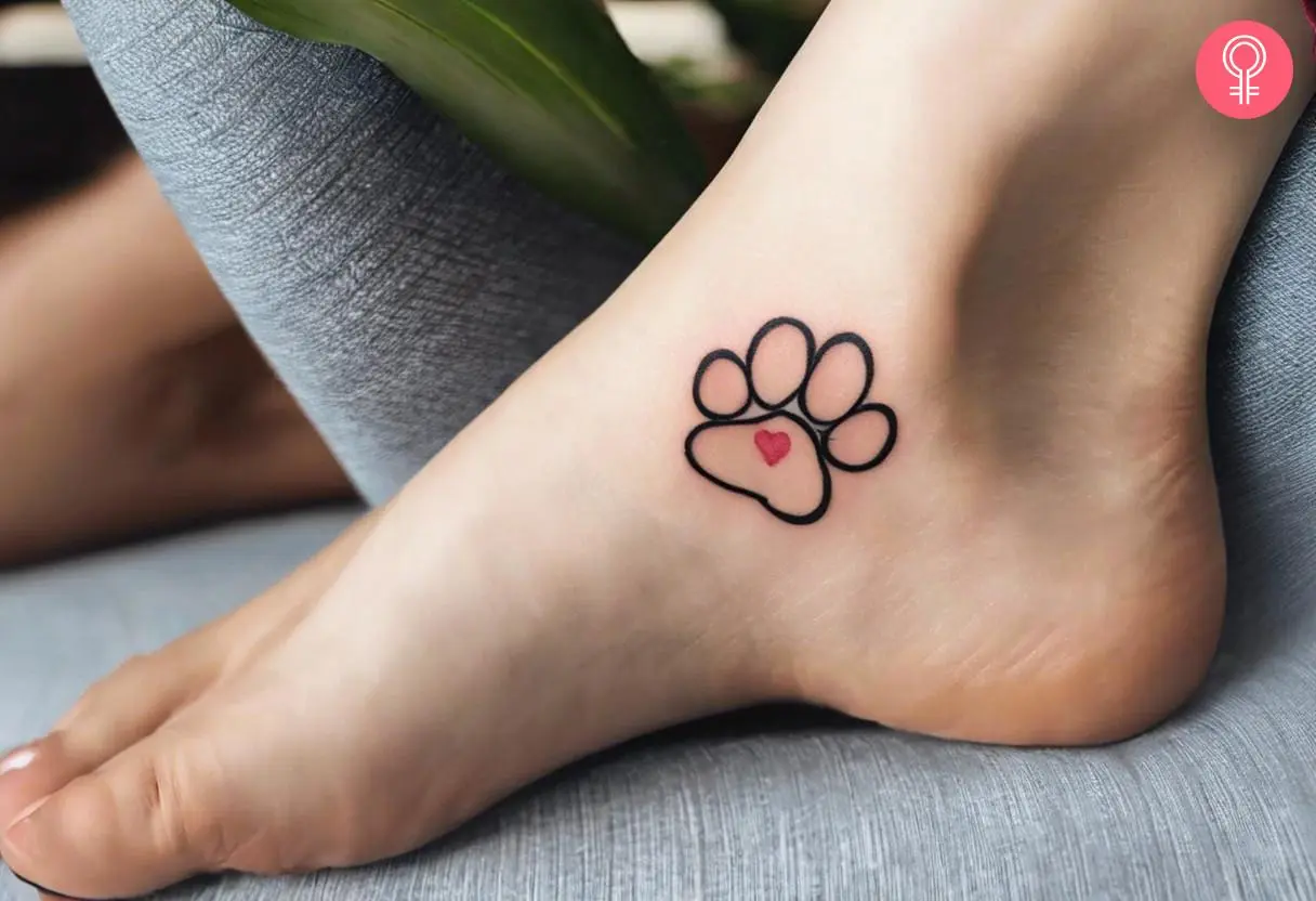 Minimalist cat paw tattoo on her ankle