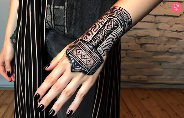 A Mjolnir tattoo on a woman’s hand