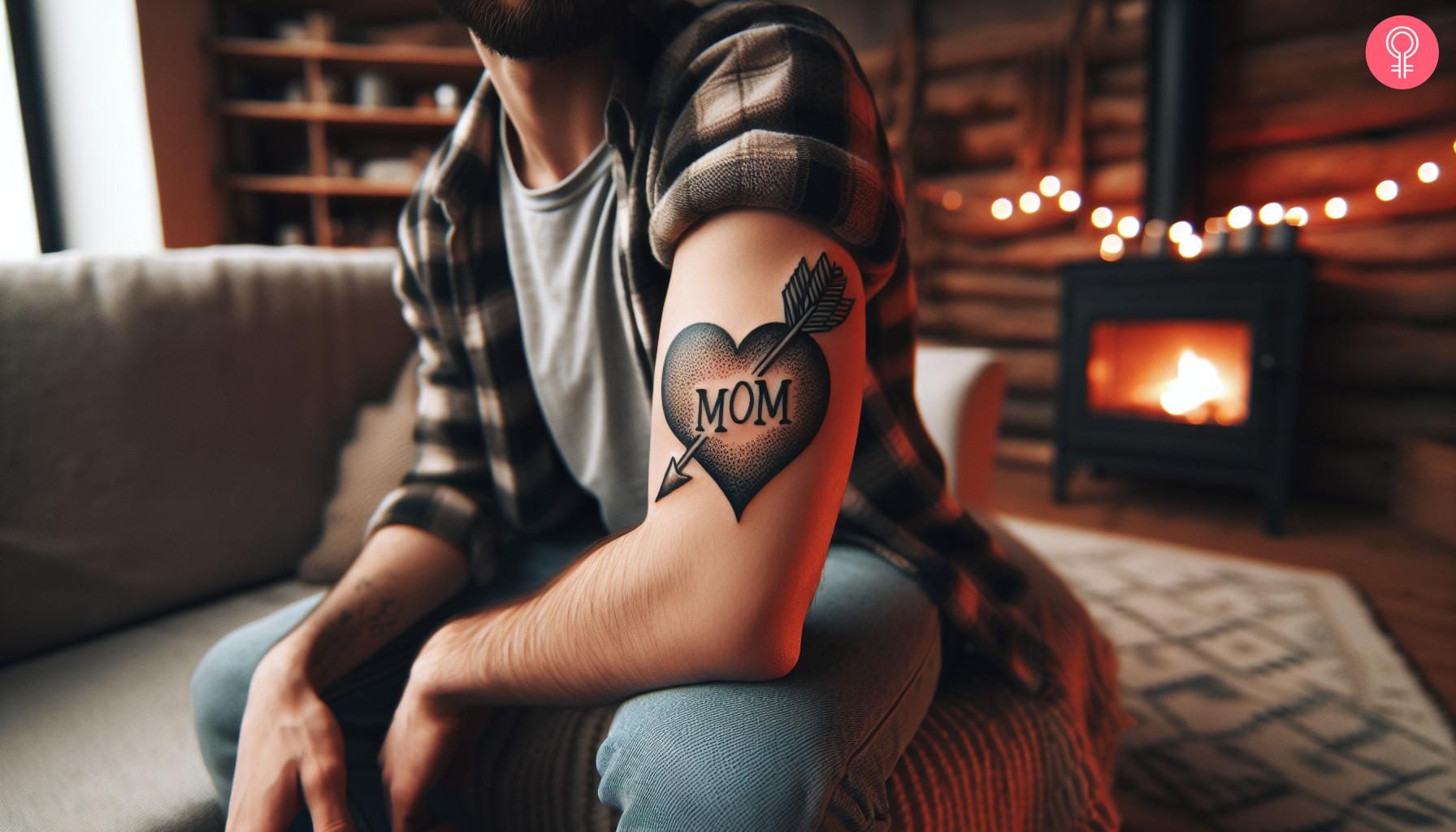 Mom heart arrow tattoo on upper arm