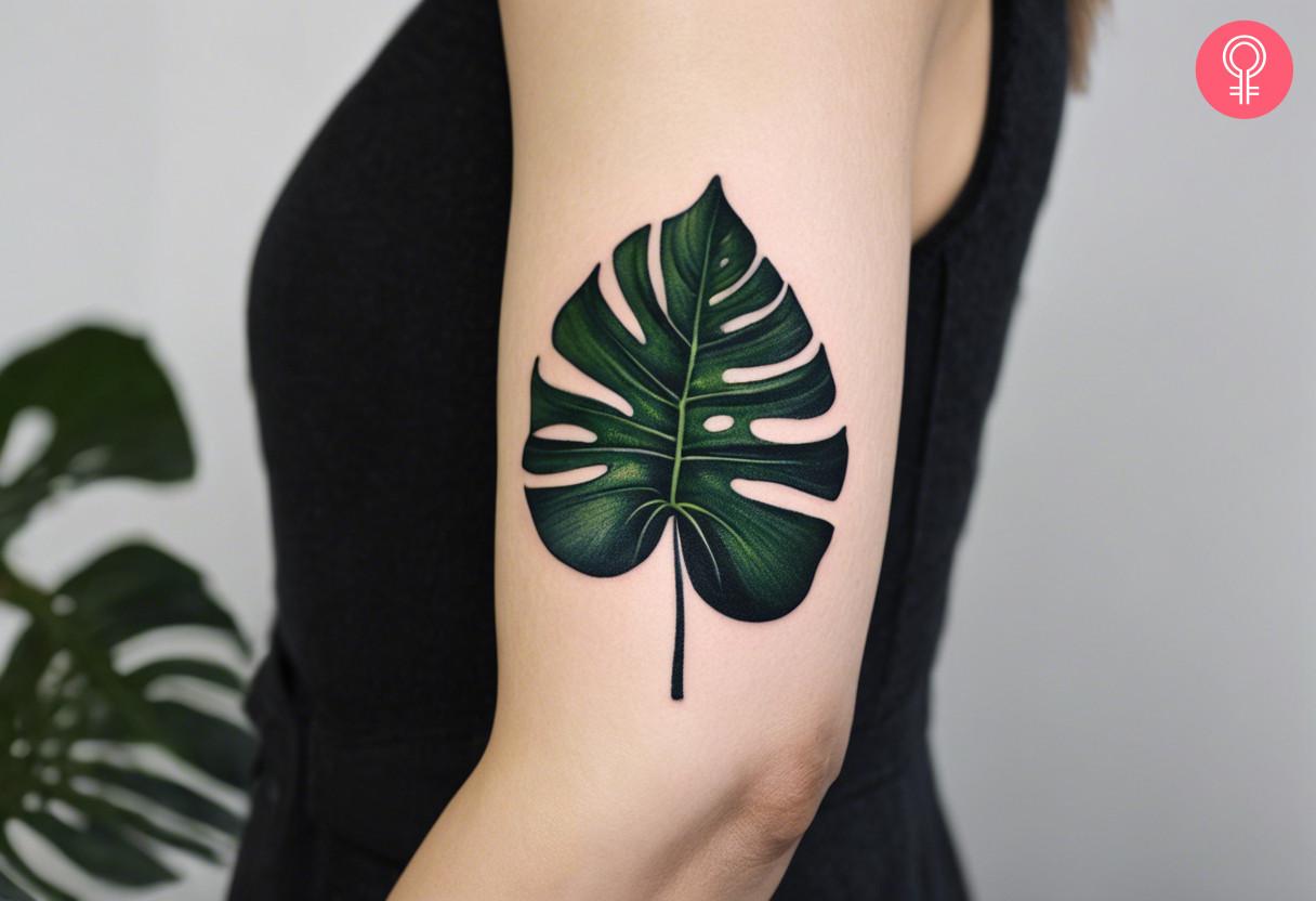 Monstera Deliciosa tattoo on a woman’s upper arm