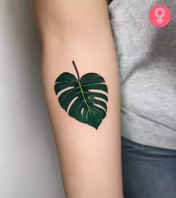 woman with a bearded dragon tattoo on her arm.