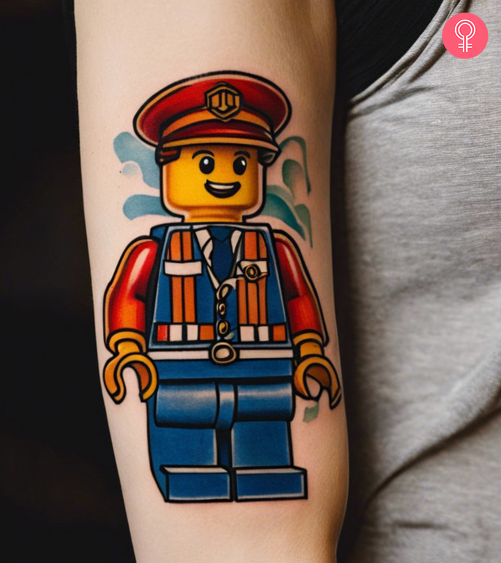 A woman with a colored Emmet, from The LEGO Movie, tattoo on the upper arm