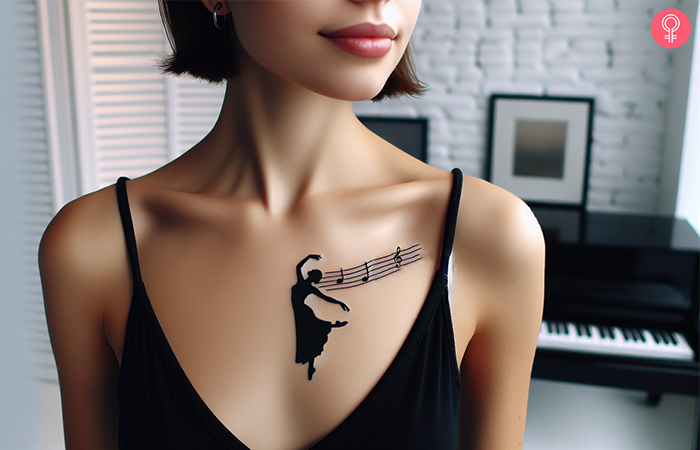 A woman wearing a ‘music and dance’ tattoo design on the upper chest