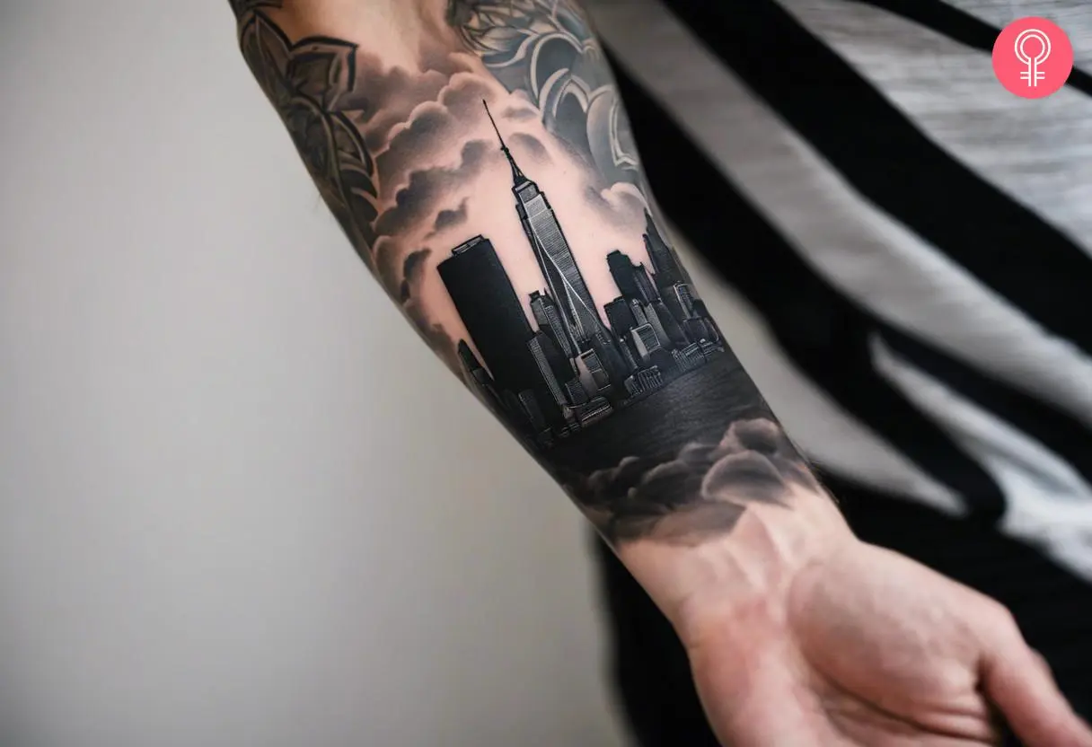 A NYC skyline tattoo sleeve on a man