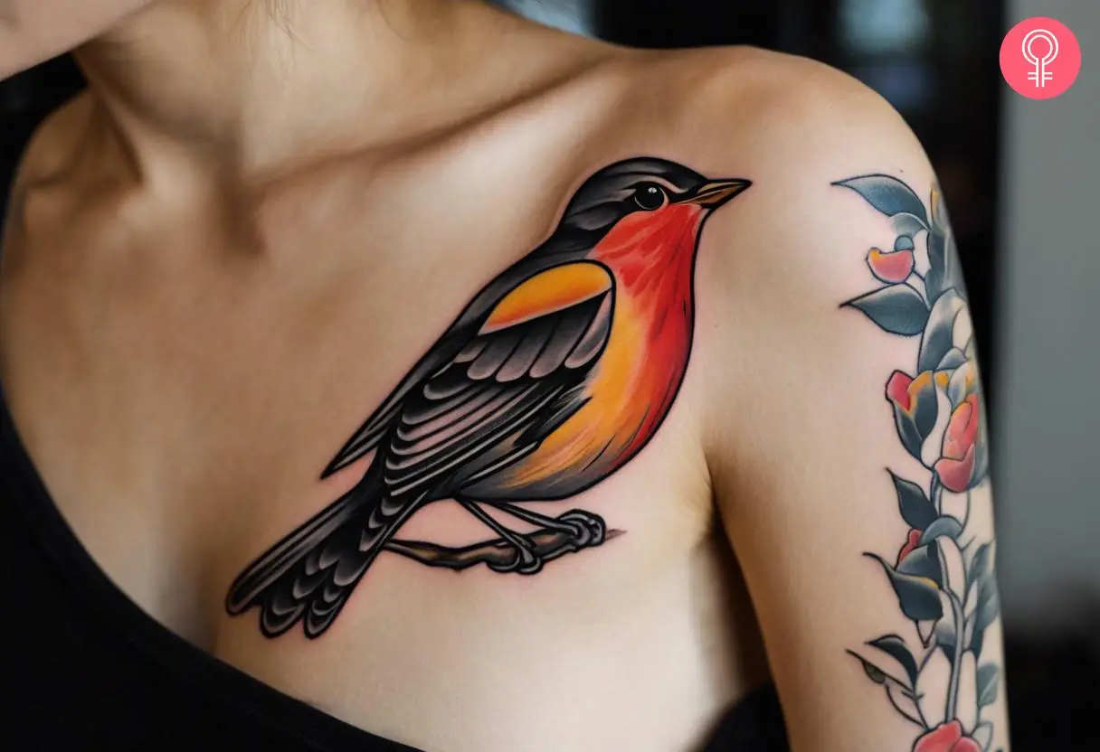 Neotraditional robin tattoo in black, grey, red, and yellow